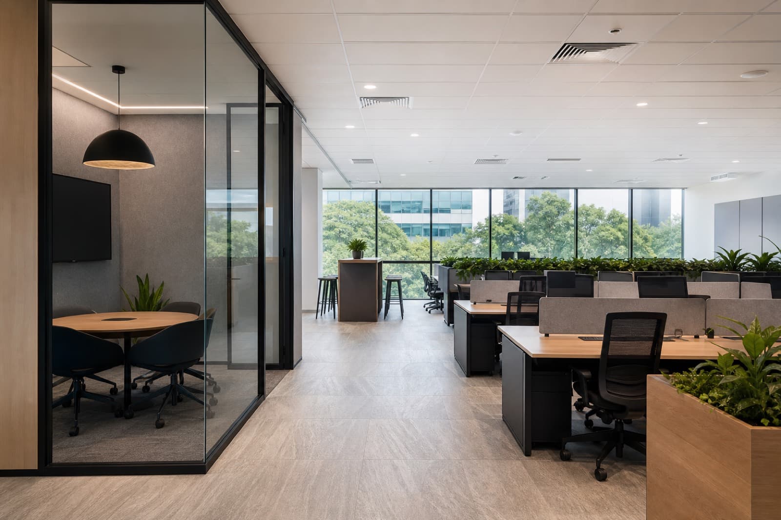 Renovated Singapore business park office with open workstations, glass huddle room, and greenery outside