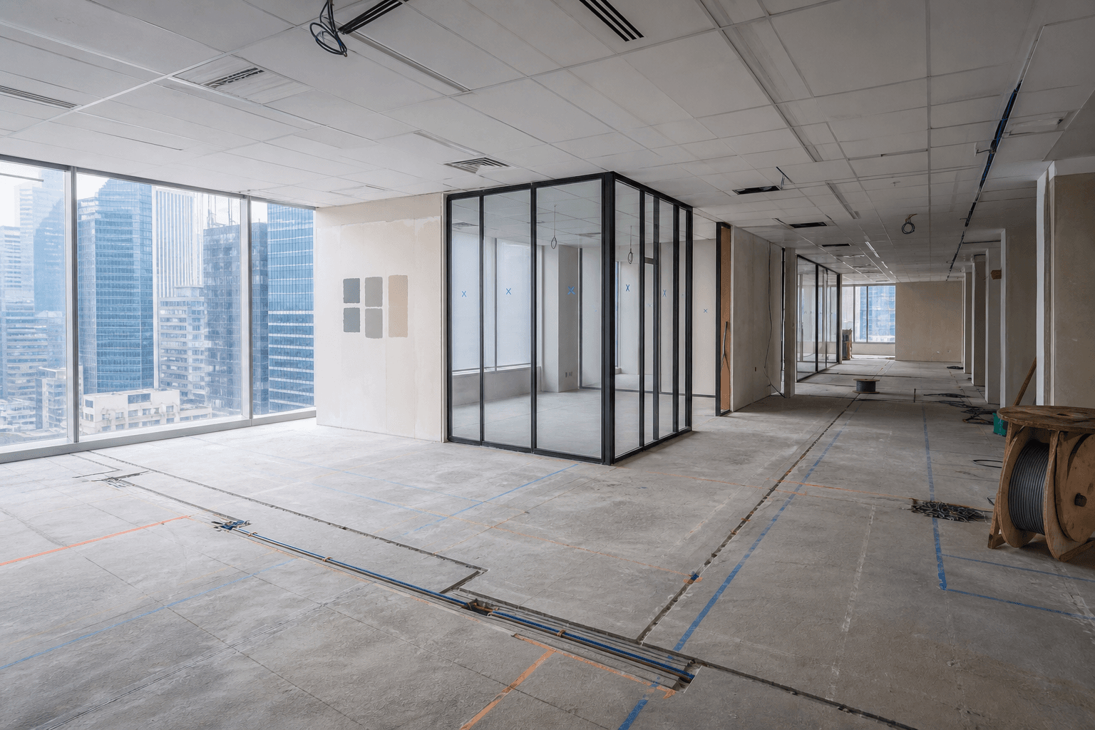 Singapore office renovation in progress with layout markings, glass framing, and electrical works underway