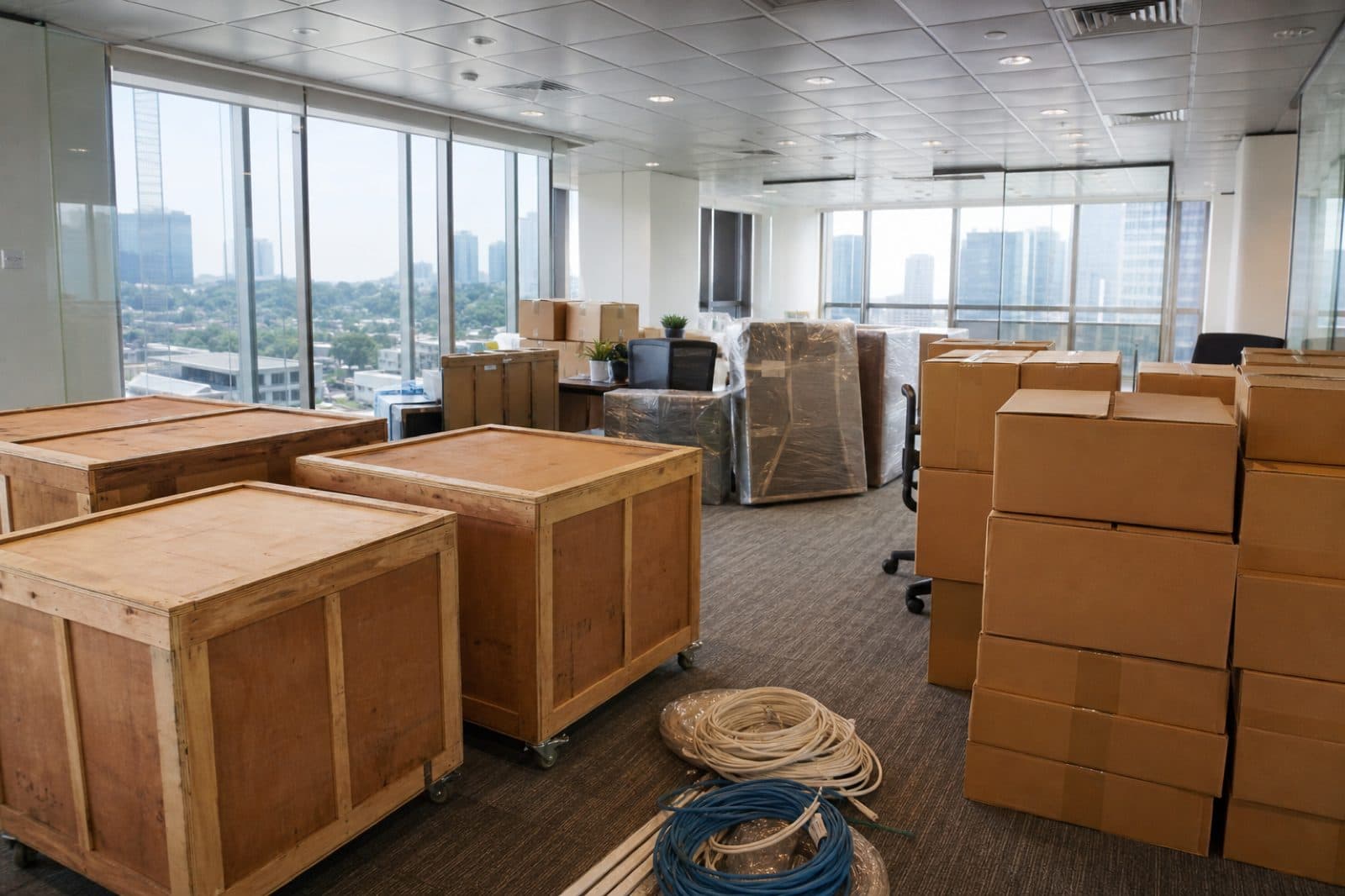 Packed boxes and moving crates in an empty Singapore commercial office ready for relocation