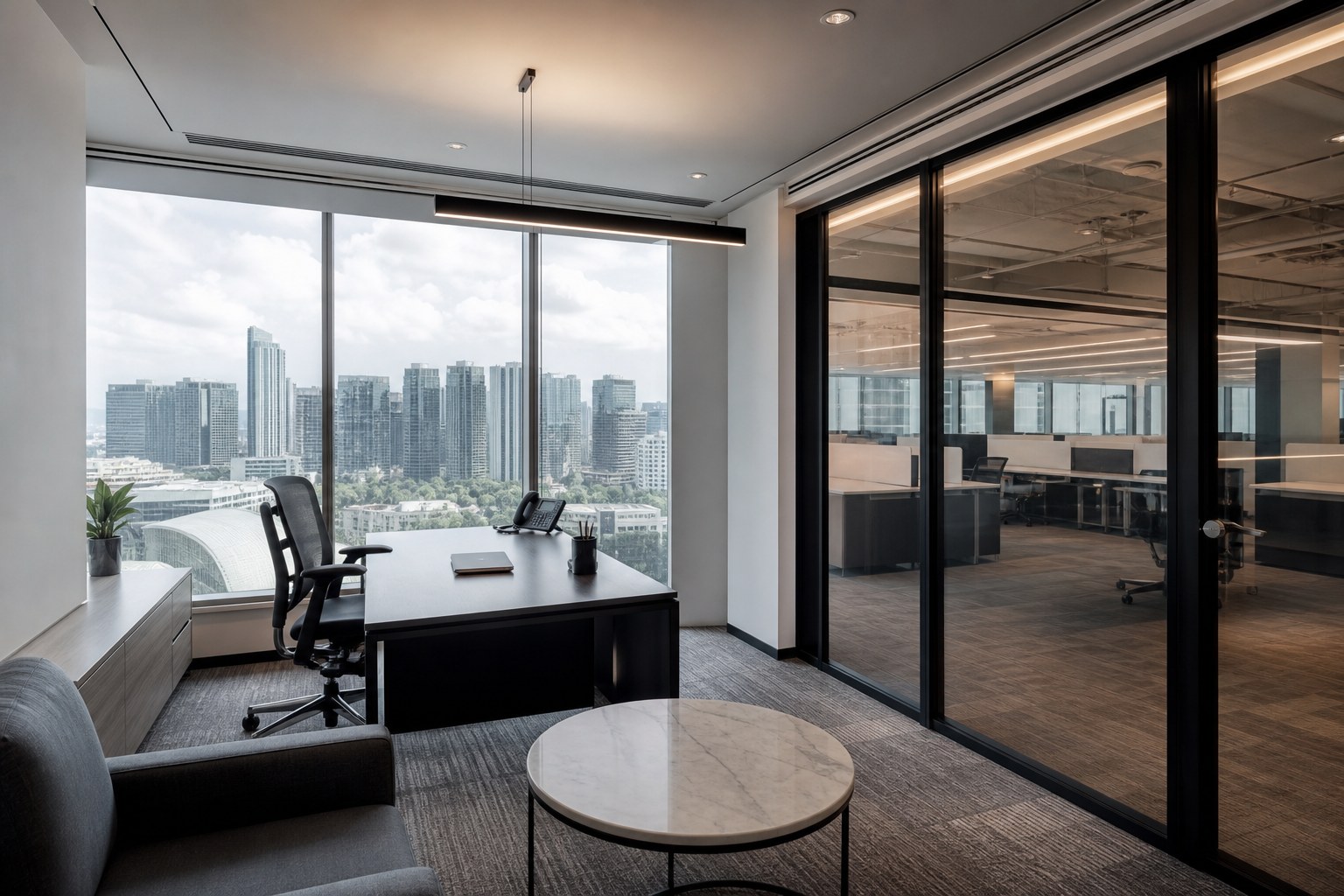 Private glass manager suite overlooking an open-plan Singapore office